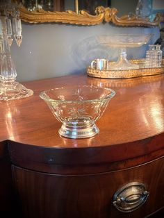 a glass bowl sitting on top of a wooden dresser