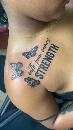 a woman's stomach with butterflies on it and the words strength written in black ink