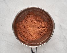 a pan filled with brown powder on top of a counter