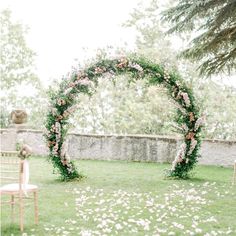 an outdoor ceremony setup with flowers and greenery