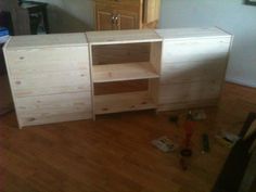 a wooden cabinet sitting on top of a hard wood floor