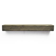 a wooden shelf sitting on top of a white wall