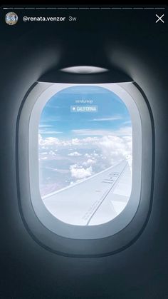 an airplane window looking out at the clouds