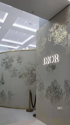 the entrance to dior's showroom is decorated with gold and white flowers