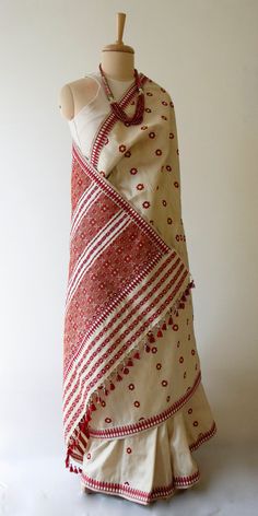 "This is a Handloom, Hundred Percent Pure Muga Silk by Mulberry Silk Saree from the looms of ASSAM. The motifs are in Acrylic. Muga Silk - The most valued silk from India. Almost exclusively reared and produced in Assam, India. It is indigenous to the Brahmaputra Valley and assiduously practiced in the districts of Assam. The moth is basically a wild moth. Hence it is categorised as Vanya Silk or Wild silk by the silk board of India.(http://csb.gov.in/silk-sericulture/silk/vanya-silk/) The yarn Luxury Handloom Tussar Silk Pashmina Shawl, Mulberry Silk Saree, Mekhala Saree, Folk Traditional Wear With Woven Motifs For Festive Occasions, Folk Style Festive Traditional Wear With Woven Motifs, Folk Style Dupatta With Woven Motifs, Folk Style Handloom Dupatta For Festivals, Red Embroidered Fabric With Woven Motifs For Festive Occasions, Red Folk Dupatta With Traditional Patterns