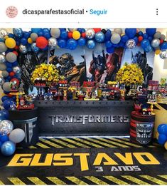 an image of a birthday party setup with balloons and decorations on the floor for a transformer themed event