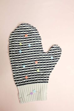 an oven mitt made out of black and white striped fabric with hearts on it