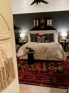 a bedroom with a bed and rugs in it