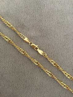 Solid twisted gold curb linked chain. This 18 inch long chain has a double link with a twisted link and is secured with a strong lobster catch. Made in London, England in the 1990's from 9k yellow gold. The chain is in very good condition. Classic Link Chain Necklace With Rope Detail, Classic Link-style Rope Chain Necklace, Classic Rope Chain Link Necklace, Gold Plated Cuban Link Rope Chain Necklace, Gold Twisted Rope Chain Jewelry, Gift Rope Chain Necklace With Figaro Link, Elegant Yellow Gold Rope Chain Necklace With Curb Detail, Elegant Yellow Gold Curb Chain Necklace, Gold Rope Chain Link Necklace