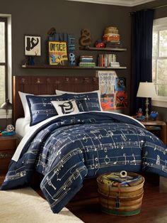 a bed room with a neatly made bed and musical notes on the comforter set