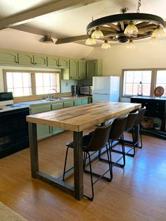 a kitchen with an island made out of wooden planks and metal barstools