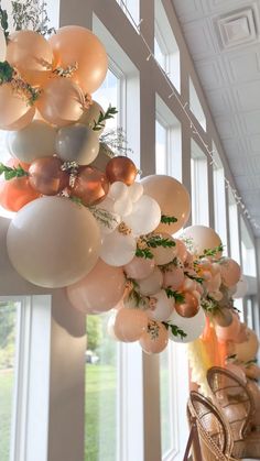 balloons and greenery are hanging from the ceiling