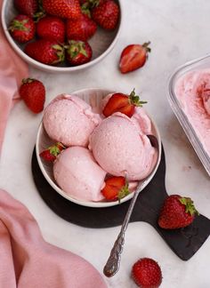 two bowls filled with ice cream and strawberries