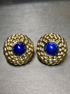 Classic and elegant lightweight puffed huggie earrings by Italian maker, FOPE. They are done in a quilted pattern of 18K yellow gold and centered by 10mm bezel set cabochon lapis. These earrings have posts with omega backs. Dimensions/Weight: Earrings measure 1" in diameter and weigh 12.8g. Condition: All stones are secure and makers marks/purity stamps are present and legible. E-TXX Luxury Round Cabochon Clip-on Earrings, Luxury Gold Earrings With Bezel Setting, Bezel Set Cabochon, Puff Quilt, Huggies Earrings, Makers Mark, Jewelry Earrings Studs, Etsy Earrings, Yellow Gold