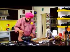 a man wearing a pink turban is cooking in a kitchen