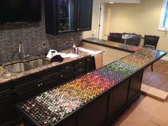 a large kitchen with black cabinets and marble counter tops