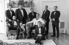 a group of men in tuxedos posing for a photo