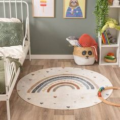 a child's bedroom with green walls and wooden flooring, including a white metal bed