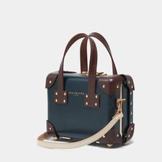 Luxury Elegant Navy Satchel, Luxury Retro Briefcase For Travel, Luxury Travel Bag With Vintage Style, Luxury Vintage Travel Bag For Business Trips, Luxury Vintage Luggage For Everyday Use, Luxury Camera Bag With Gold-tone Hardware For Travel, Luxury Vintage Travel Bag With Handles, Luxury Travel Camera Bag With Gold-tone Hardware, Vintage Luxury Luggage For Everyday Use