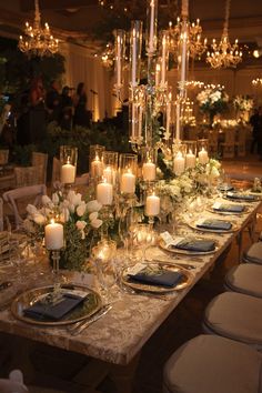 a long table is set with candles and flowers for an elegant dinner or party event