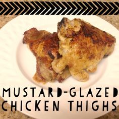 two chicken thighs on a white plate with the words mustard - glazed chicken thighs over them