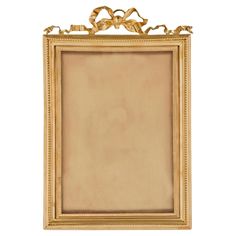 an antique gold frame with ornate decoration