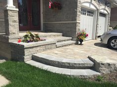 a car parked in front of a house with stone steps leading up to the door