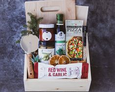 a wooden box filled with food and condiments on top of a gray surface