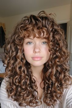 Curly haircuts are all about celebrating your texture and finding a style that complements your face shape. Whether you have loose waves, bouncy spirals, or tight coils, there’s a curly haircut out there that will Curly With Fringe, Haircuts For Girls With Curly Hair, Sabrina Carpenter Haircut On Curly Hair, Layered Permed Hair, Spiral Perms For Medium Length Hair, Curly Bangs Haircut, Spiral Perm Before And After, Curly Girl Haircut, Long Curly Hair With Bangs