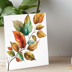 a watercolor painting of leaves on a white background art boarder next to a potted plant