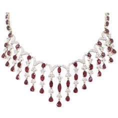 Spectacular ruby and diamond necklace and earring set all in 18 carat white and yellow gold. They are both set with a total of sixty nine rubies - a combination of marquise, pear shaped, round and oval shaped rubies with a minimum approximate total weight of 50.00 carats and round brilliant cut diamonds with an approximate total weight of 12.00 carats. Hand made intricate design with the rubies set in open back claw settings and diamonds set in a mix of rub-over and grain settings. This is a one Formal Necklace, Ruby And Diamond Necklace, Bridal Diamond Necklace, Cluster Ring Set, Cascade Necklace, Gem Ruby, Girl Accessories, Diamond Necklace Set, Proposal Box