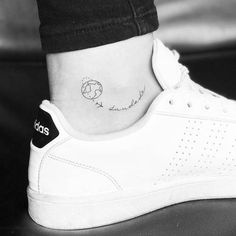 a person with a small tattoo on their ankle