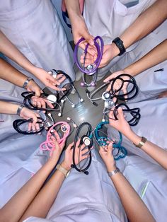 a group of people holding their hands together in a circle on top of a bed