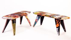 two tables made out of skateboards with different colors and designs on the top one is multicolored