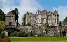 an old castle like building surrounded by greenery