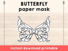 the butterfly paper mask is shown on a wooden background