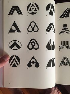 an open book with black and white logos on it