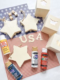 wooden stars and other crafting supplies laid out on a checkered tablecloth with the word usa cut out