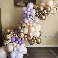 a bunch of balloons hanging from the ceiling