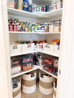 an organized pantry with baskets and food in the bottom shelf is seen from the inside