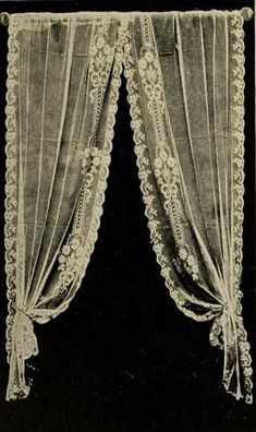 an old black and white photo of two curtains with lace trimmings on them