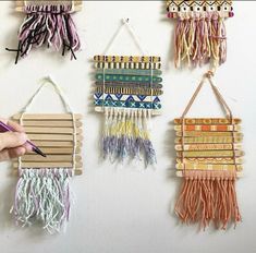 the wall hangings are made out of wood and have different colored tassels