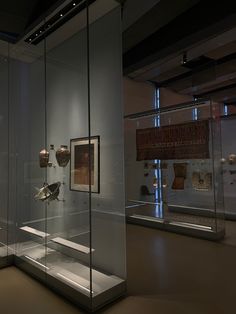 an exhibit with glass cases containing ancient artifacts