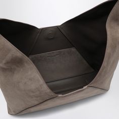 This hobo bag is like that perfect cup of tea, comforting and effortlessly stylish. Made with the softest suede in a rich dark grey, it’s your go-to for both casual outings and special occasions. Plus, the little details like the adjustable handle and magnetic fastening make it as practical as it is chic. Adjustable top handle for customizable comfort Magnet fastening for easy access Embossed lettering logo on the front for a touch of elegance Suede Shoulder Bag With Magnetic Closure For Daily Use, Daily Use Suede Shoulder Bag With Magnetic Closure, Modern Hobo Bag With Suede Lining For Daily Use, Modern Hobo Bag For Daily Use With Suede Lining, Modern Hobo Bag For Daily Use, Modern Suede Bucket Bag For Everyday, Hobo Chic, Perfect Cup Of Tea, Hobo Style