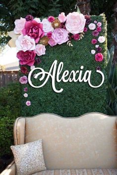 a couch with flowers on it and the word alexia spelled in cursive letters