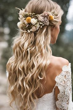 a woman with long blonde hair and flowers in her hair is wearing a flower crown