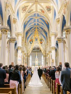 a bride and groom are walking down the aisle at their wedding ceremony in a cathedral