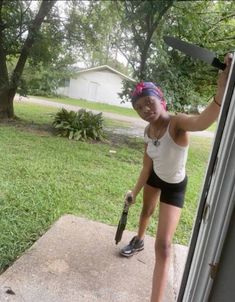 a woman is holding onto the handle of an open door while standing on concrete steps