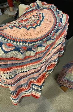 a crocheted blanket sitting on top of a chair