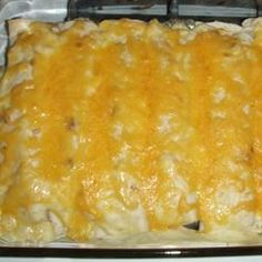 a casserole dish with cheese and meat in the bottom, on top of a stove